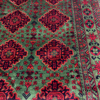 Green Bukhara rug 3.1m x 2m, hand-knotted, durable, traditional design, ideal for living rooms.